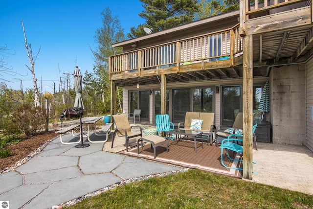 11896 Cabana Shores Rd, Williamsburg, MI 49690 - rear view of house with a patio area and a balcony