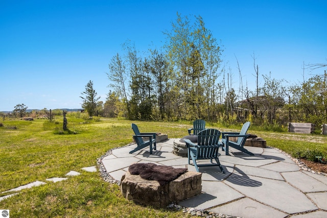 11896 Cabana Shores Rd, Williamsburg, MI 49690 - view of patio with an outdoor fire pit