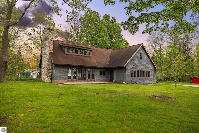 6675 Walker St, Benzonia, MI 49616 - view of front of home featuring a chimney and a front lawn