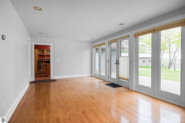 6675 Walker St, Benzonia, MI 49616 - empty room with light wood-style floors, baseboards, and recessed lighting