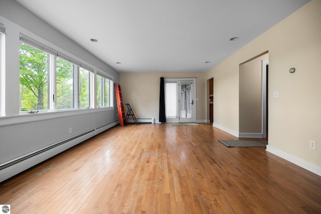 6675 Walker St, Benzonia, MI 49616 - unfurnished room featuring baseboard heating, light wood-style flooring, baseboards, and recessed lighting