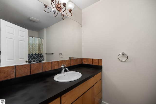 6675 Walker St, Benzonia, MI 49616 - full bath featuring vanity and a chandelier