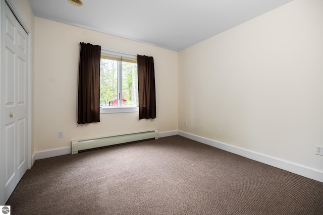 6675 Walker St, Benzonia, MI 49616 - empty room with a baseboard radiator, carpet flooring, and baseboards