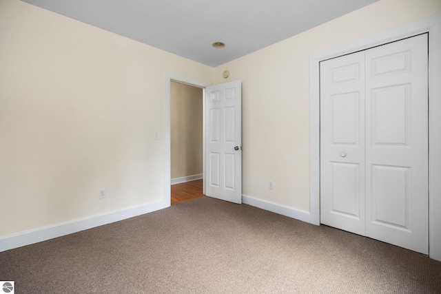 6675 Walker St, Benzonia, MI 49616 - unfurnished bedroom with carpet floors, baseboards, and a closet