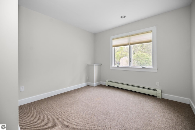 6675 Walker St, Benzonia, MI 49616 - carpeted spare room featuring a baseboard radiator and baseboards