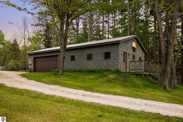 6675 Walker St, Benzonia, MI 49616 - garage at dusk with driveway
