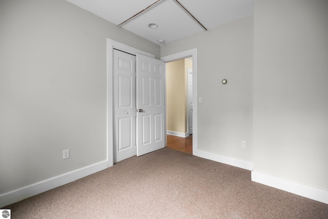 6675 Walker St, Benzonia, MI 49616 - unfurnished bedroom with carpet flooring, baseboards, and a closet