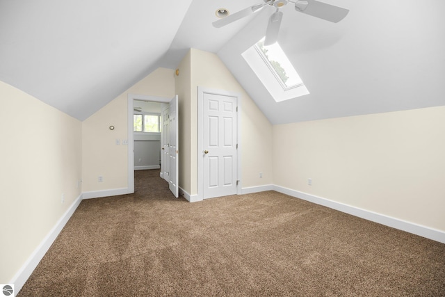 6675 Walker St, Benzonia, MI 49616 - additional living space with carpet flooring, a ceiling fan, lofted ceiling, baseboards, and a skylight