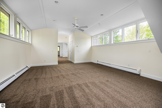 6675 Walker St, Benzonia, MI 49616 - carpeted empty room featuring a baseboard heating unit, lofted ceiling, a baseboard radiator, a ceiling fan, and baseboards