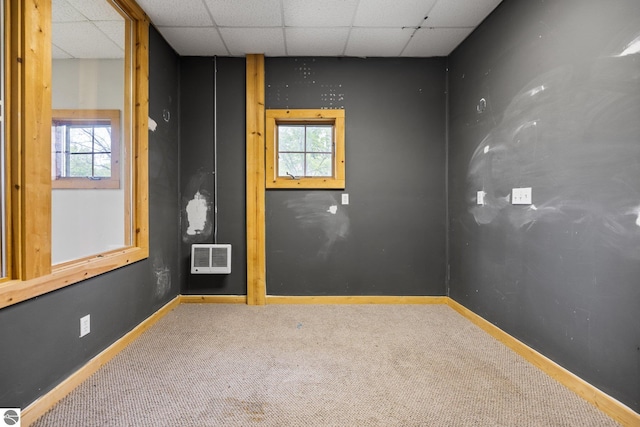 6675 Walker St, Benzonia, MI 49616 - spare room featuring carpet flooring, a drop ceiling, and baseboards