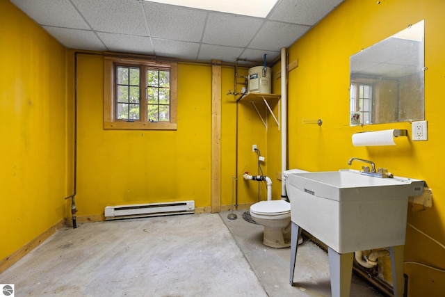 6675 Walker St, Benzonia, MI 49616 - bathroom featuring a baseboard radiator, toilet, unfinished concrete floors, and a drop ceiling
