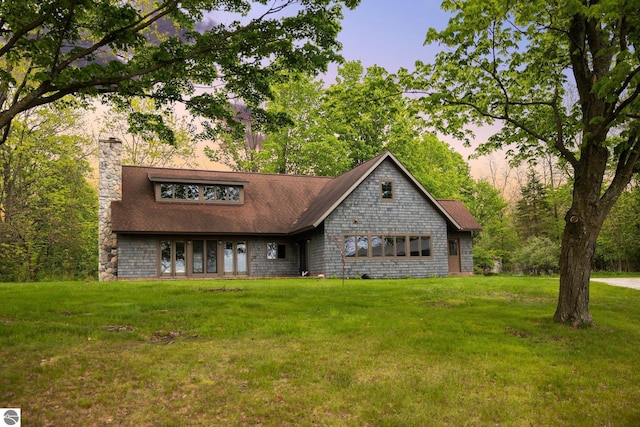 6675 Walker St, Benzonia, MI 49616 - view of front of home with a chimney, a front lawn, and roof with shingles