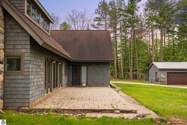 6675 Walker St, Benzonia, MI 49616 - view of patio / terrace with an outbuilding and a garage