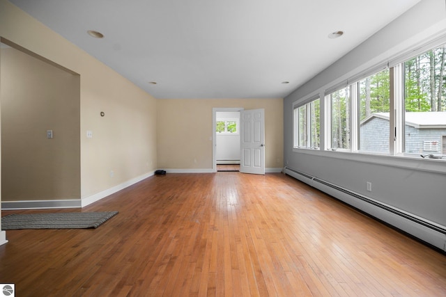 6675 Walker St, Benzonia, MI 49616 - unfurnished room featuring a baseboard heating unit, baseboards, and light wood finished floors