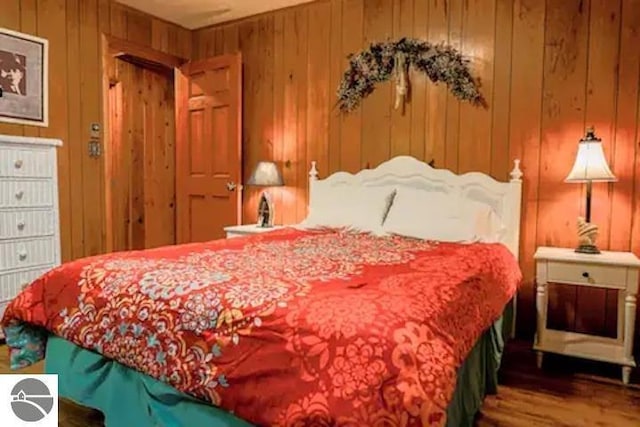 2401 J Maddy Pkwy, Interlochen, MI 49643 - bedroom with wood finished floors and wood walls