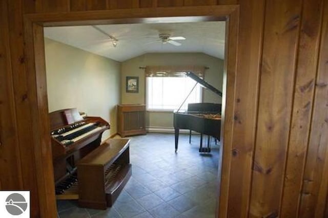 2401 J Maddy Pkwy, Interlochen, MI 49643 - sitting room with vaulted ceiling, a ceiling fan, tile patterned floors, and baseboard heating