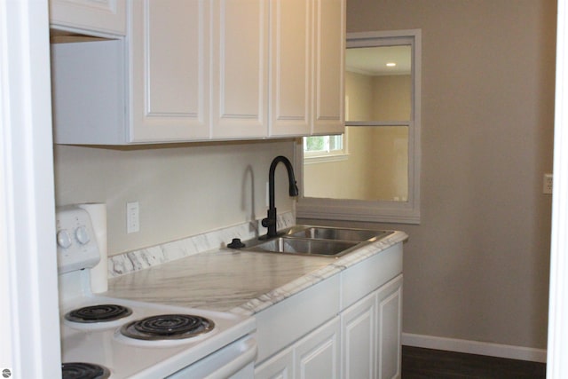 1023 S Elizabeth St, Mount Pleasant, MI 48858 - kitchen with white electric range, a sink, light countertops, and white cabinetry