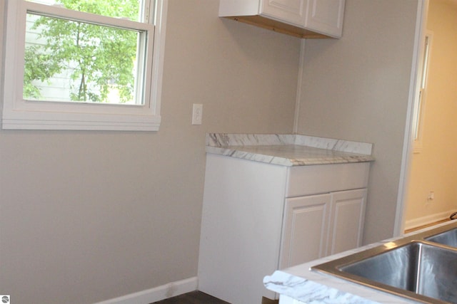 1023 S Elizabeth St, Mount Pleasant, MI 48858 - kitchen featuring white cabinetry and light countertops