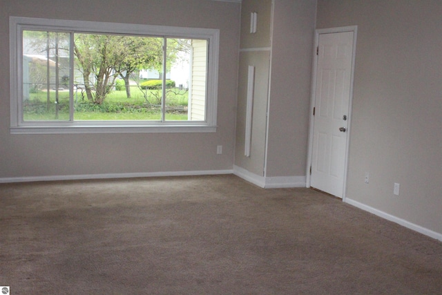 1023 S Elizabeth St, Mount Pleasant, MI 48858 - carpeted spare room featuring baseboards