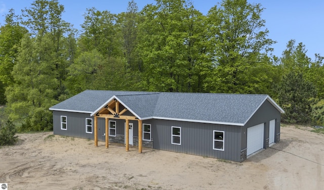 11285 Lakeshore Dr, Buckley, MI 49620 - view of front of house with a garage and a shingled roof