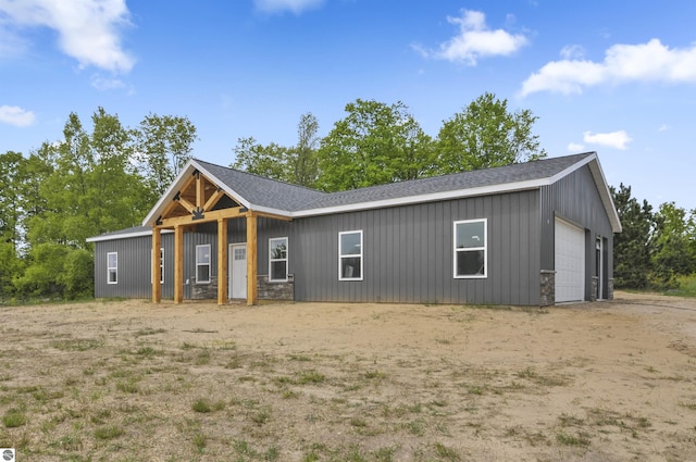 11285 Lakeshore Dr, Buckley, MI 49620 - view of front of house featuring a shingled roof, board and batten siding, and a garage