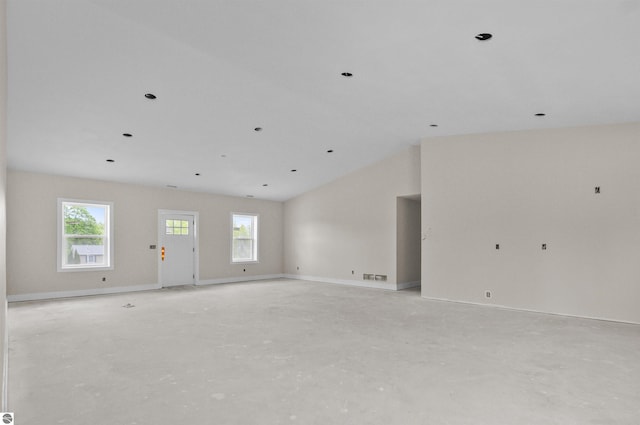 11285 Lakeshore Dr, Buckley, MI 49620 - spare room featuring plenty of natural light, lofted ceiling, baseboards, and concrete flooring