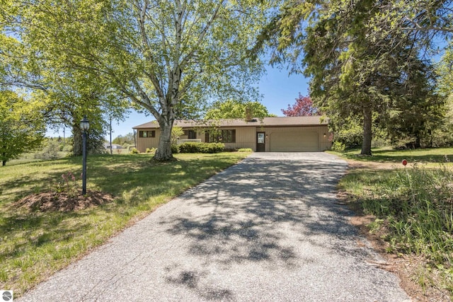 906 Michigan Ave, Frankfort, MI 49635 - single story home with a garage, driveway, and a front lawn