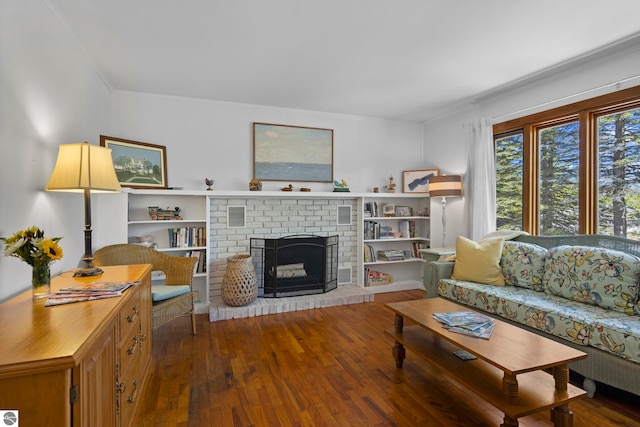906 Michigan Ave, Frankfort, MI 49635 - living room featuring wood finished floors, ornamental molding, and a brick fireplace