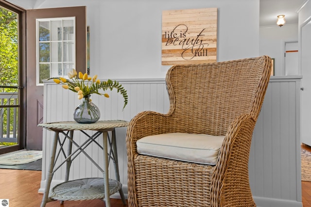 906 Michigan Ave, Frankfort, MI 49635 - living area featuring wood finished floors, plenty of natural light, wainscoting, and ornamental molding