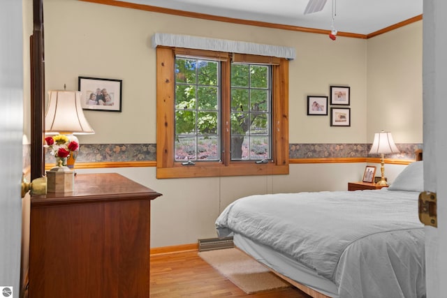 906 Michigan Ave, Frankfort, MI 49635 - bedroom with wood finished floors, ornamental molding, and baseboards