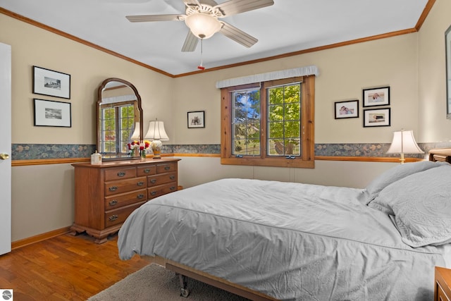 906 Michigan Ave, Frankfort, MI 49635 - bedroom with wood finished floors, wainscoting, crown molding, a ceiling fan, and baseboards