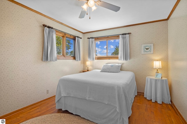 906 Michigan Ave, Frankfort, MI 49635 - bedroom featuring ornamental molding, wood finished floors, wallpapered walls, ceiling fan, and baseboards