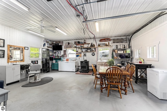 6313 E 34 1/2 Rd, Cadillac, MI 49601 - garage with refrigerator and a wood stove