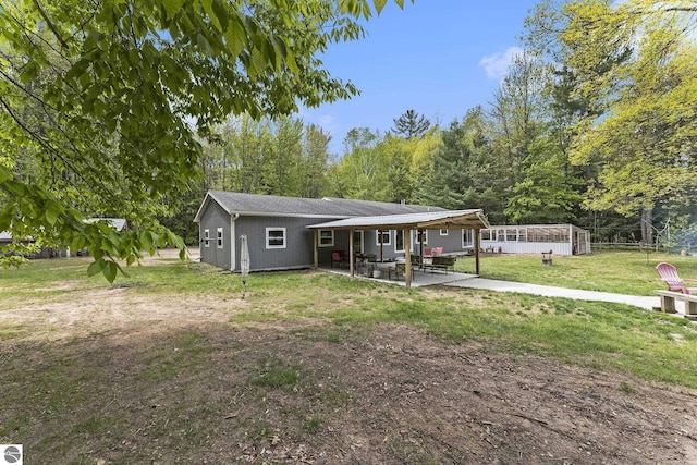 6313 E 34 1/2 Rd, Cadillac, MI 49601 - view of front of property with a patio, a front yard, and an attached carport