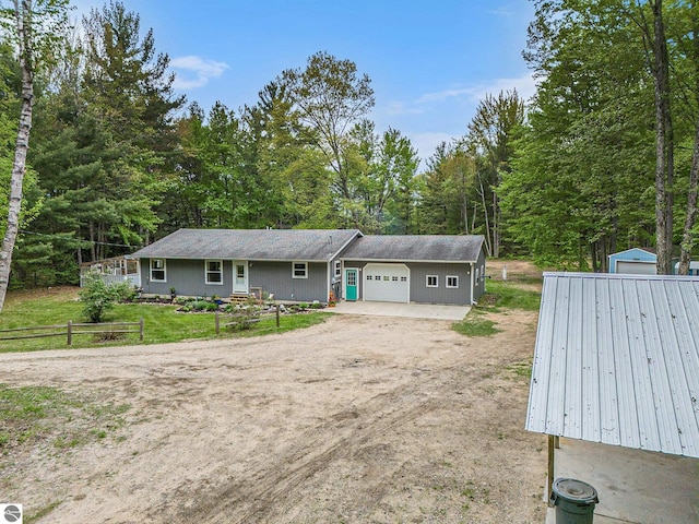 6313 E 34 1/2 Rd, Cadillac, MI 49601 - view of front facade with an attached garage and dirt driveway