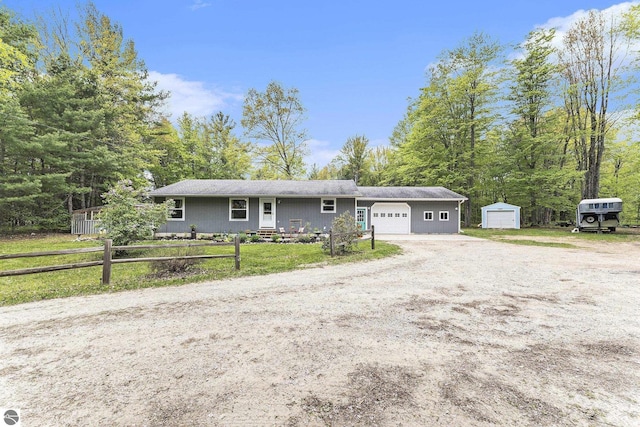 6313 E 34 1/2 Rd, Cadillac, MI 49601 - ranch-style home featuring dirt driveway and an attached garage