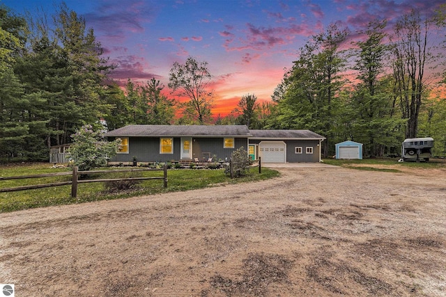 6313 E 34 1/2 Rd, Cadillac, MI 49601 - single story home featuring driveway, a fenced front yard, and an attached garage