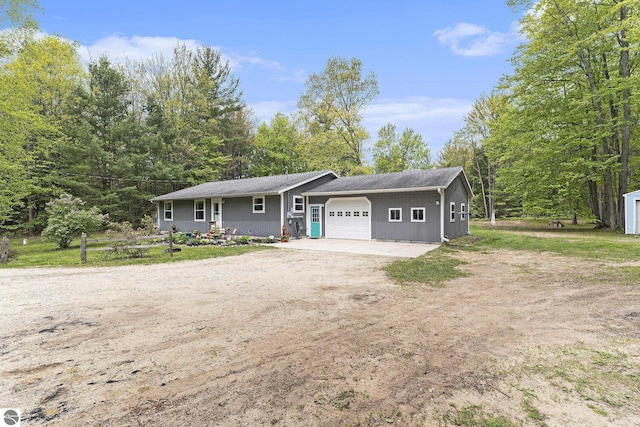 6313 E 34 1/2 Rd, Cadillac, MI 49601 - ranch-style home with a garage and dirt driveway