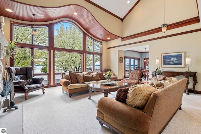 6853 S W Bay Shore Dr, Traverse City, MI 49684 - living room with high vaulted ceiling, carpet flooring, crown molding, recessed lighting, and baseboards