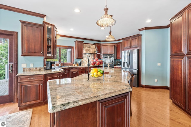 6853 S W Bay Shore Dr, Traverse City, MI 49684 - kitchen featuring stainless steel fridge with ice dispenser, light wood finished floors, glass insert cabinets, pendant lighting, and light stone countertops