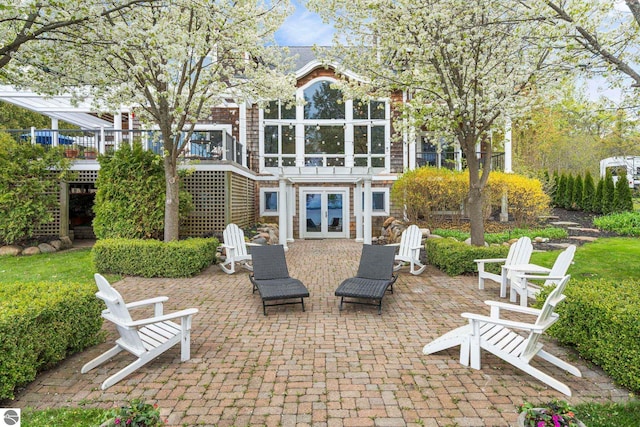 6853 S W Bay Shore Dr, Traverse City, MI 49684 - rear view of property with french doors, a patio area, and a wooden deck