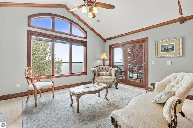6853 S W Bay Shore Dr, Traverse City, MI 49684 - carpeted living room with vaulted ceiling, healthy amount of natural light, baseboards, a ceiling fan, and ornamental molding