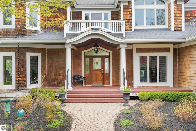 6853 S W Bay Shore Dr, Traverse City, MI 49684 - entrance to property featuring covered porch and a shingled roof