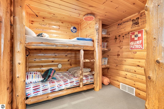 6853 S W Bay Shore Dr, Traverse City, MI 49684 - carpeted bedroom with wooden ceiling and wooden walls