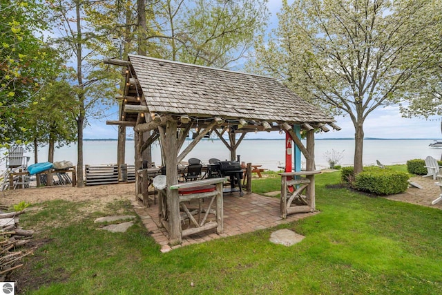 6853 S W Bay Shore Dr, Traverse City, MI 49684 - view of grassy yard featuring a gazebo, a water view, and a patio