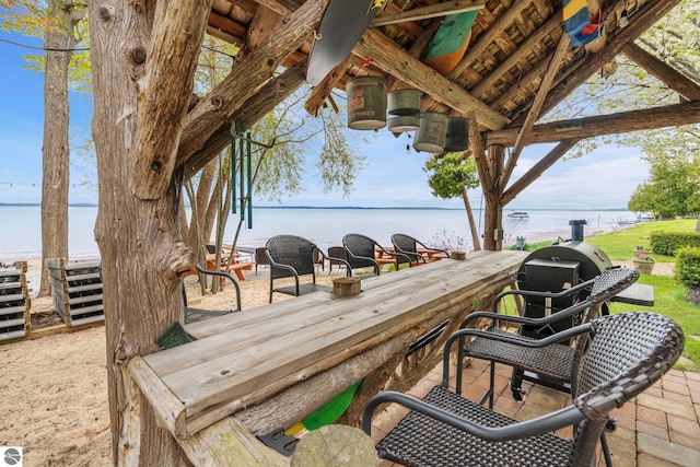 6853 S W Bay Shore Dr, Traverse City, MI 49684 - wooden terrace with a water view and area for grilling