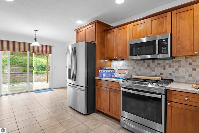 5151 Hidden Gables Dr, Traverse City, MI 49684 - kitchen with appliances with stainless steel finishes, brown cabinets, light countertops, tasteful backsplash, and recessed lighting
