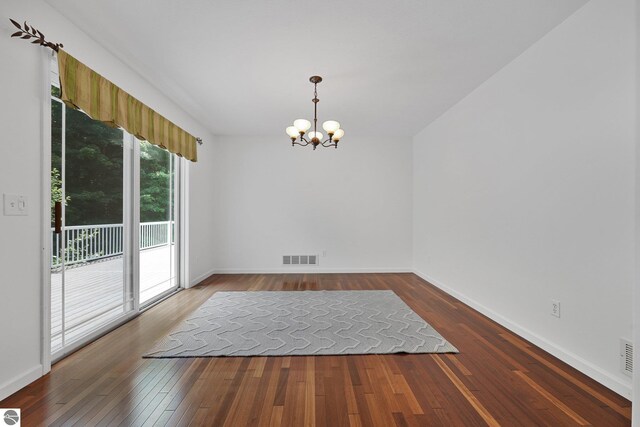 5151 Hidden Gables Dr, Traverse City, MI 49684 - unfurnished room with a chandelier and wood-type flooring