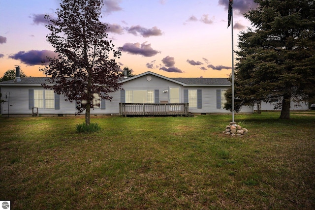 9170 Townline Rd, Kingsley, MI 49649 - view of front facade with crawl space, a deck, a lawn, and a shingled roof