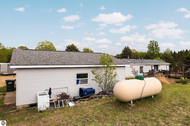 9170 Townline Rd, Kingsley, MI 49649 - back of property featuring a deck, a yard, and a shingled roof
